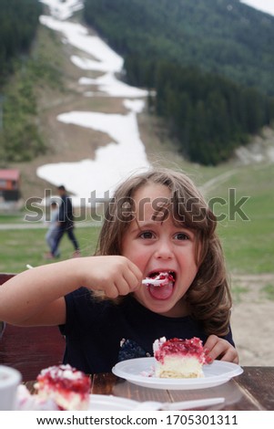 The 4 year old Italian girl eats her birthday cake