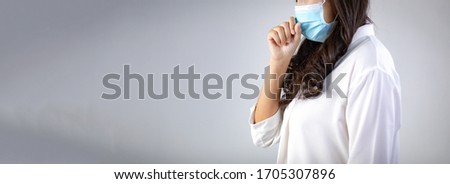 Portrait of Asian Sick woman with protective mask coughing on white background. Mask protection against virus. Covid-19, coronavirus pandemic. Horizontal panorama banner for web and text design