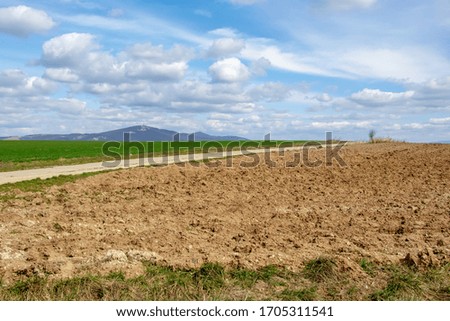 Plowed field. Morning Spring landscape. View on the City of Nitra, Slovakia