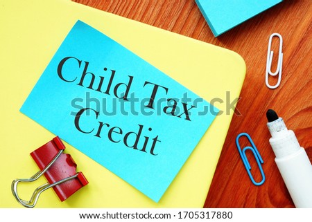 The photo says Child Tax Credit. Notepad, pen, marker.