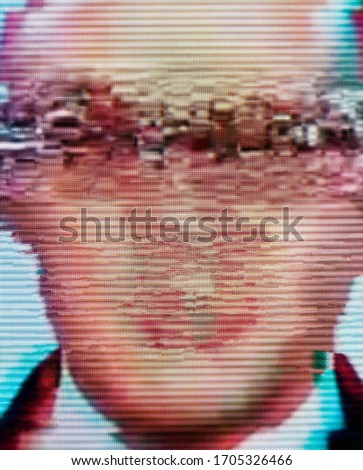 Man's face on the screen. Close-up. Glitch. Digital errors on the screen.