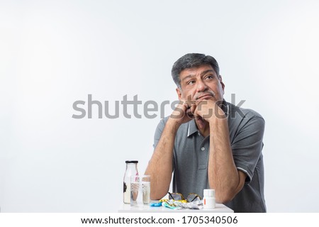 Elderly Man with all his medicines.