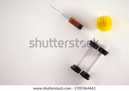 Syringe with covid-19 vaccine, medical tube, and corona virus icon on white background. 2019 global pandemic.