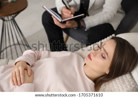 Psychotherapist and patient in office. Hypnotherapy session Royalty-Free Stock Photo #1705371610