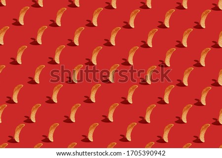 Crispy chips on a red background. Modern Food pattern Royalty-Free Stock Photo #1705390942