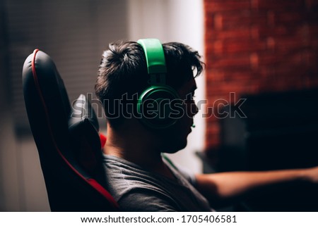 computer games, playing place, young gamer plays computer games with headphones,