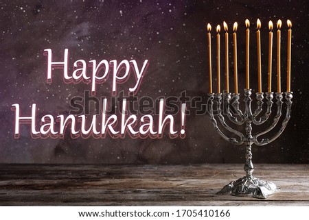 Silver menorah on wooden table. Happy Hanukkah!