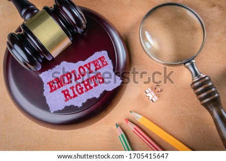 Employee Rights. Legal aid, compensation, obligations and rights concept. Judge's hammer, stationery and magnifying glass on the table