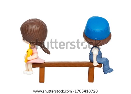 Annoyed couple ignoring each other while sitting on a bench.  Social distancing and self-isolation concept.