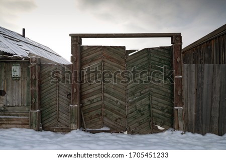 Old wooden gate of the village house.