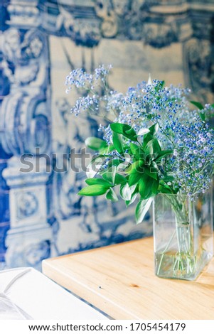 Still life of blue flowers with blue  azulejo ceramic background wall 