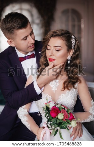 Stock Photo - Portrait of beautiful young wedding couple at black background
