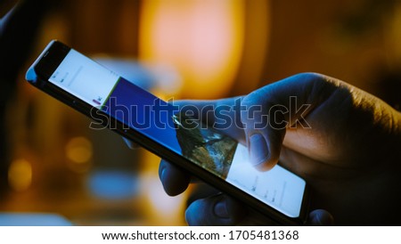 Close-up Macro: Person Holding and Using Smartphone, Browsing through Pictures on Social Network Wall. Finger Scrolling Social Media App Feed: Travel, Animals, Food. Mock-up Application Design