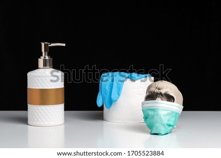 Creative composition with a hand soap and toilet paper and skull on white table. Coronavirus outbreak. Pandemic concept.