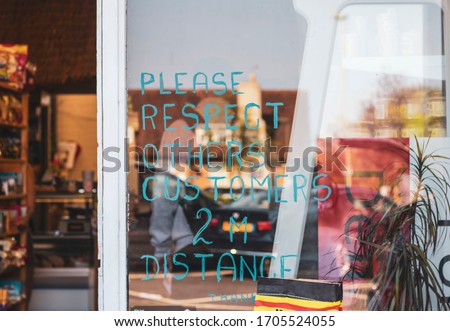 Sign on one of English grocery shops saying: "Please respect others customers 2M Distance. Thank you"New rules due to coronavirus.
