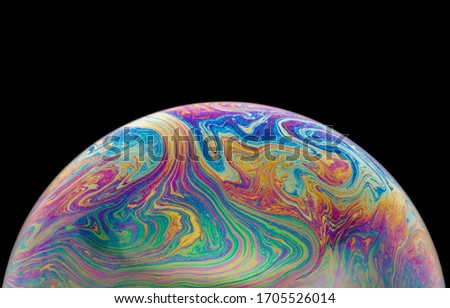 image of a soap bubble with a beautiful textured surface and rainbow stains. 