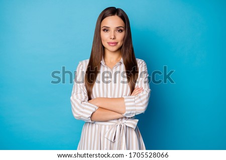 Photo of pretty charming lady arms crossed calm self-confident chief long perfect groomed hairdo wear striped casual summer spring dress isolated blue color background