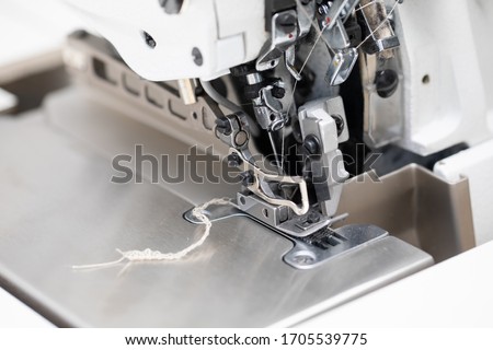 The overlock sewing machine is used to finish the edges of materials such as skirts, dresses and blouses. Royalty-Free Stock Photo #1705539775