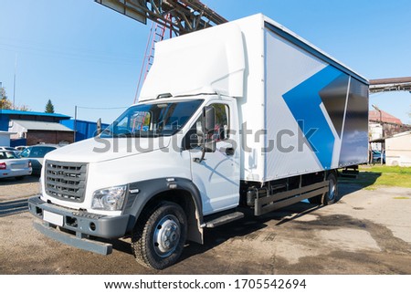 Loading white trucks at the facility. Delivery or shipment of goods conceptual image.