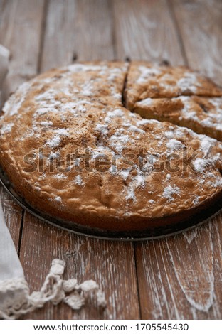 Homemade pie with cherries and apples on a dark rustic wooden board background. Rustic style food