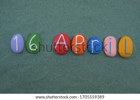 16 April, calendar date composed with colored and carved stones over green sand