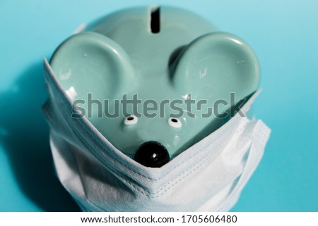 money box, bank blue mouse with medical mask on a blue background