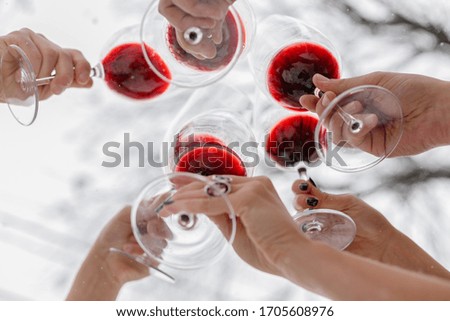 wineglasses with wine in hand
