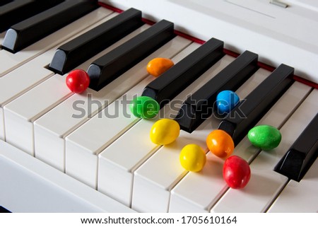 Easter colorful candies at digital piano keyboard 