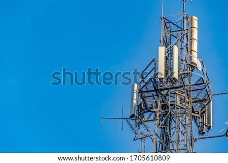 Close up shot of Communications tower hosting various antennas and dishes