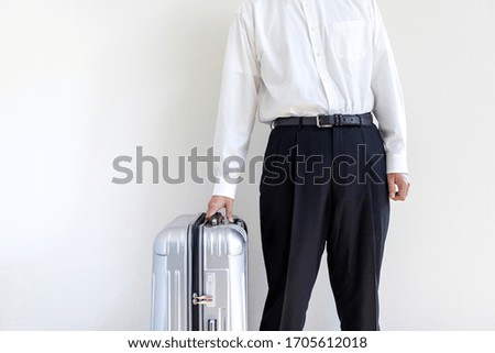 Man in a business shirt with a suitcase