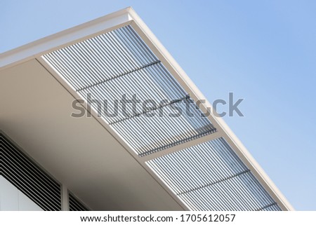 steel awning of modern house. exterior metal louver shading against blue sky. Royalty-Free Stock Photo #1705612057