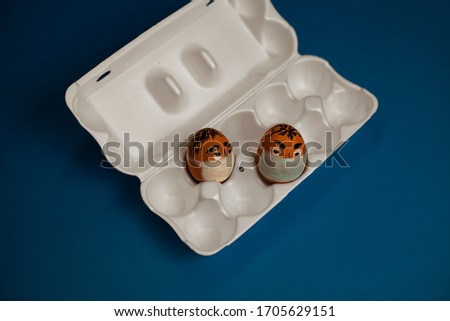 a bunch of masked eggs during Quarantine. on a blue background.