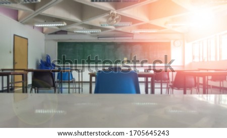 School classroom closed in blur background without young student; Blurry view of empty examination class room no kid or teacher with chairs and tables in campus university.