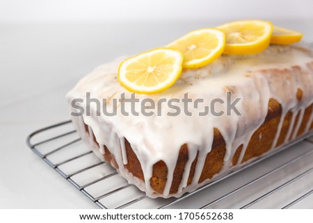 Lemon poppy seed loaf on cooling rack Royalty-Free Stock Photo #1705652638