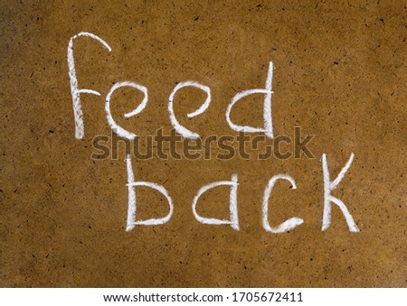 feedback handwritten inscription in chalk on a plain background