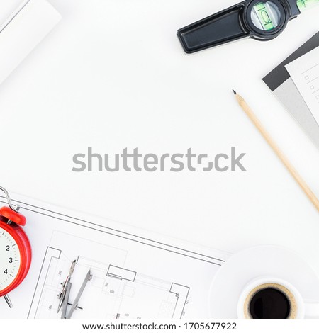 Creative flat lay overhead top view blueprint flat project plan hot coffee cup alarm clock and office supplies on decorator table workspace swatches tools and equipment background copy space concept