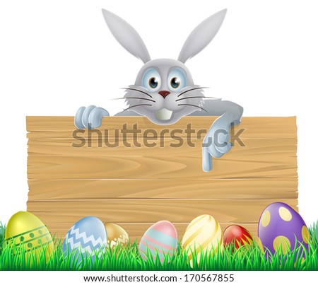 Easter eggs and Easter bunny sign with the Easter bunny peeping over the sign and pointing at the message