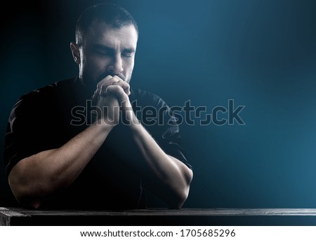 Human prayer's hands folded on the background