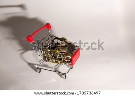 Shopping trolley with coins top view