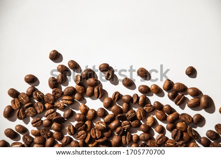 Natural coffee beans on the white background. Beautiful photo with coffee. Roasted coffee.