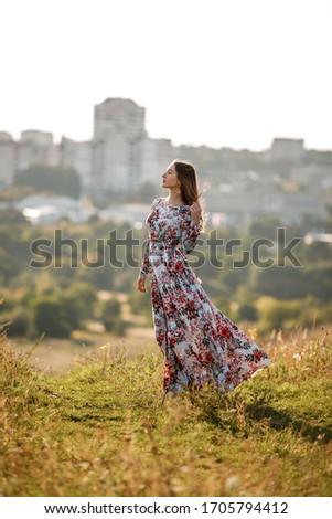 Portrait of beautiful young girl outdoors in spring. young girl in a field