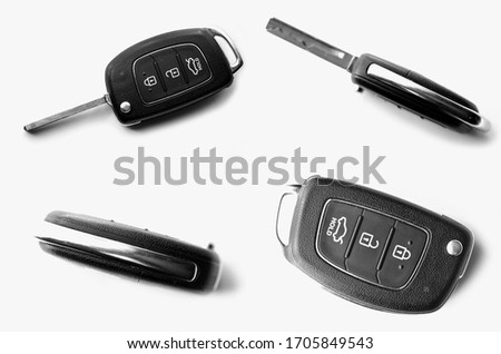 Folding car key close-up top view isolated on a white background. Auto keys set different sides. Black, chrome and grey colors. 3D.
