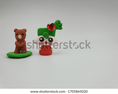 animal figures made of colored bright plasticine in bags on a white background