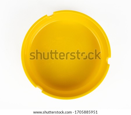 Yellow round ashtray on a white background isolate