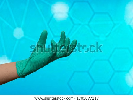Doctor's hands in medical gloves. Blue background. Prevention of covid-19
