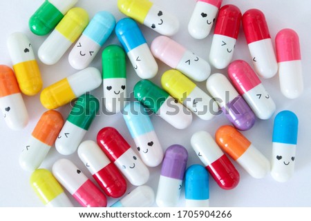 Different colorful medicine capsules on white background. Love stops virus concept.