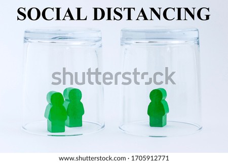 Toy wooden people under a glass on light background with text. Concept of staying physically apart, at home, social distancing, quarantine during pandemic of coronavirus COVID-19.