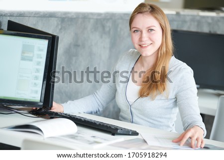 female designer using computer while working with design project