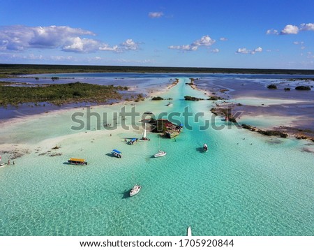aerial view of turquoise channel at blue lagoon with boats blue sky