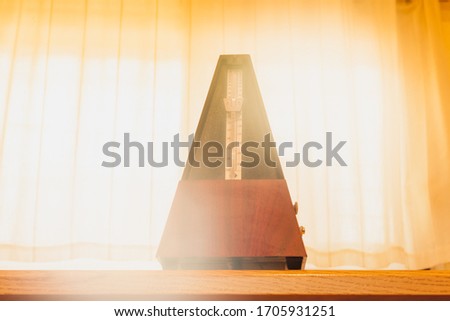 wooden metronome with warm light